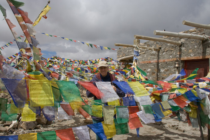 Mark among more prayer flags at the top of the pass